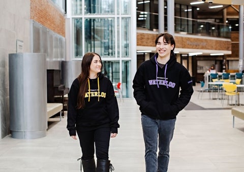 Two students walking together in conversation