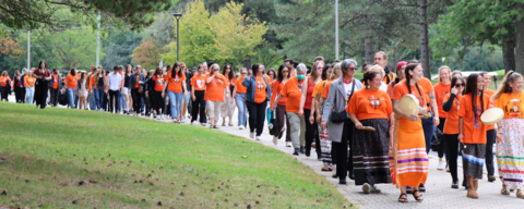 people in orange shirt walking