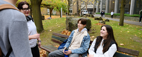 Students talking and sitting on the bench