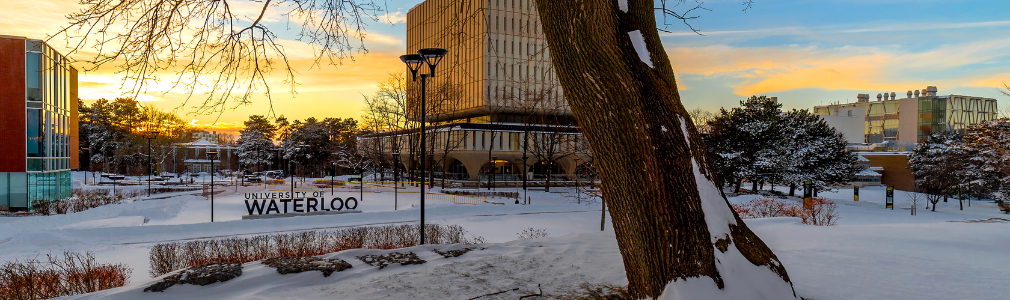 The Dana Porter Library and the University of Waterloo sign at sunset in the winter time