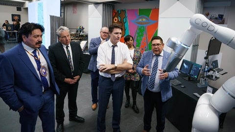 Justin Trudeau and other special guests examining a robot