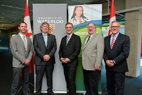 people in front of Innovation fund banner and Waterloo banner