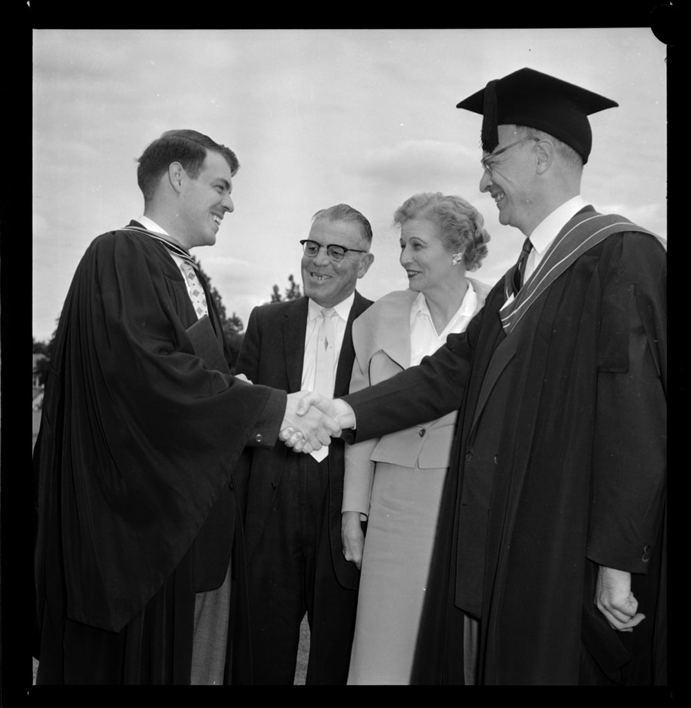 Ron Mullin (left) shaking hands wutg dean of arts W.K. Thomas (right).