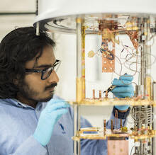 Vadiraj Ananthapadmanabha adjusting a super-cooled dilution refrigerator