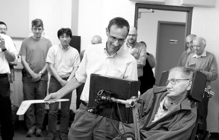 Raymond Laflamme presents Stephen Hawking with a boomerang