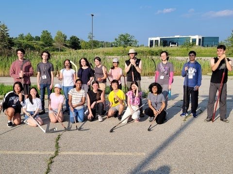 Students posing with hockey sticks