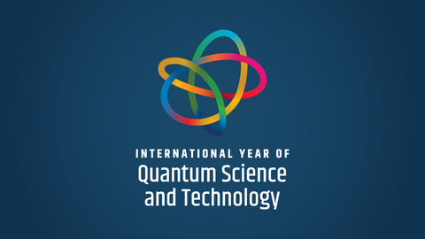 A line that changes color from yellow to red to blue to orange to pink and to green forms a knot on a blue background. Underneath the knot white text says “International Year of Quantum Science and Technology.”