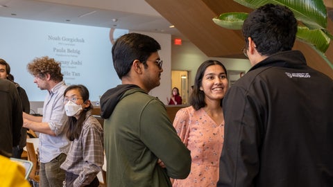 A close up of several IQC students talking