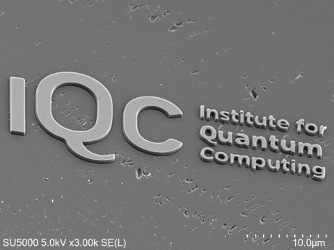 Electron microscope image about 40 micrometers wide showing IQC's logo etched into a diamond surface