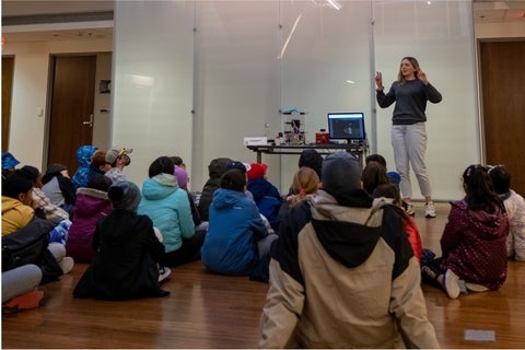 Lauren Brown presenting the dust trap demo to a group of students