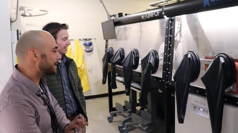 Nathan Nelson-Fitzpatrick and Taso Alkiviades looking at the inert atmosphere glove box