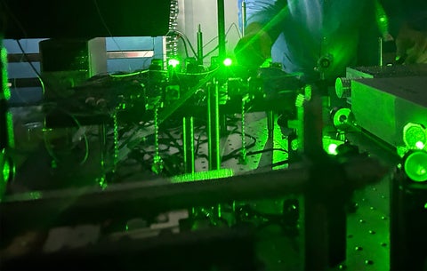 A laser table illuminated with green laser light