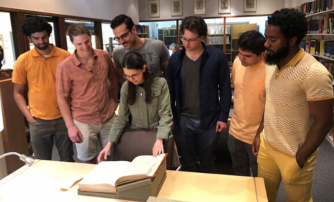 Shayan Majidy and his collaborators looking at a textbook