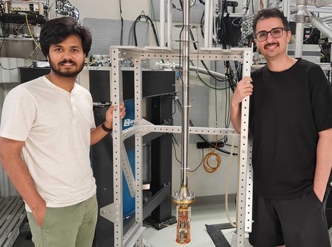 IQC students Pritam Priyadarsi and Sahand Tabatabaei by a low temperature scanning force microscope. 