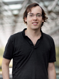 Headshot of Shalev Ben-David, wearing a dark shirt, glasses and dark hair