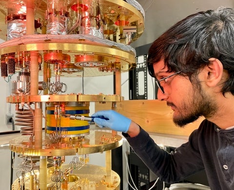 Student working on a dilution cryostat