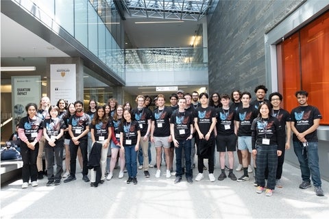 USEQIP students group shot, showing approx. 40 students wearing t-shirts with cats on them