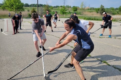 USEQIP students playing ball hockey with IQC members
