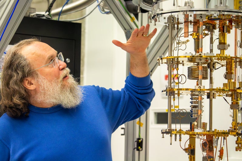 Christopher Wilson, IQC faculty, points to a superconducting quantum computer