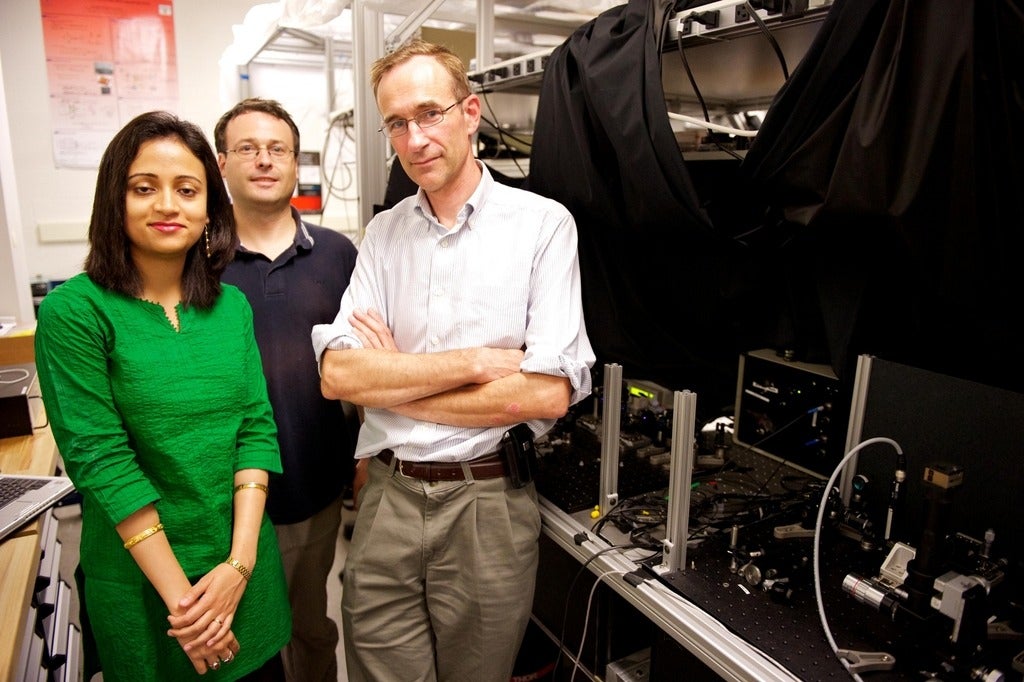 Urbasi Sinha standing with Raymond Laflamme at an IQC lab