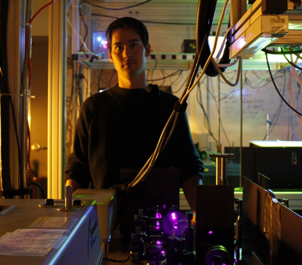 Jonathan Lavoie standing next to the experimental setup 