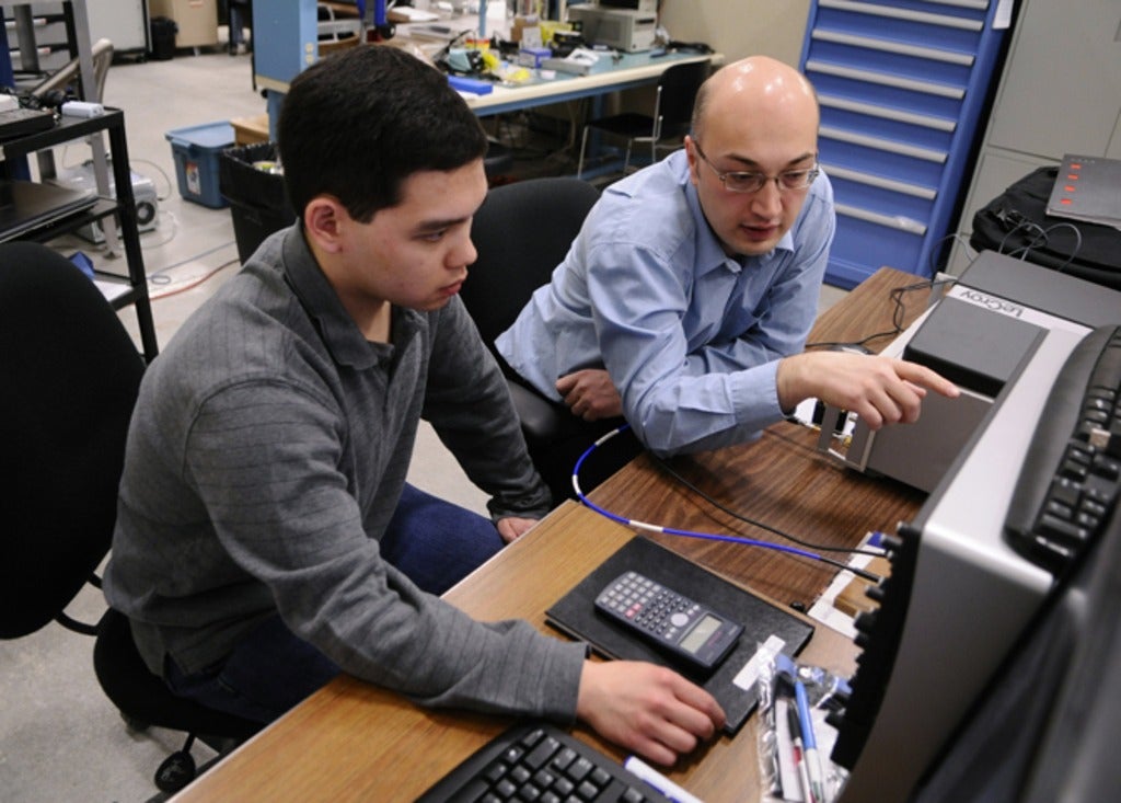 Adrian Lupascu working with a student