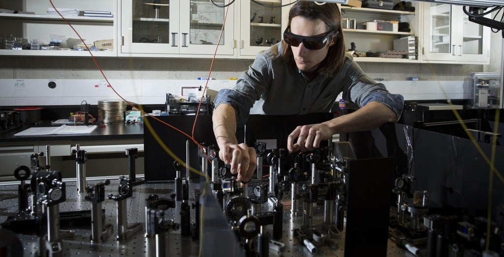Jean-Philippe Maclean works on his optics experiment