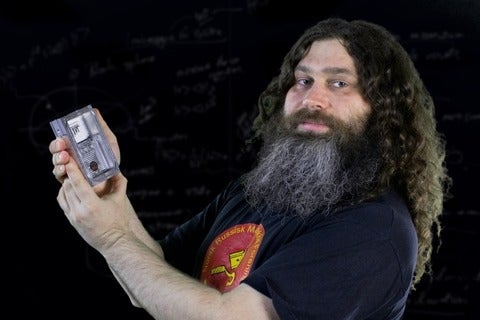Vadim Makarov holding a piece of quantum hardware