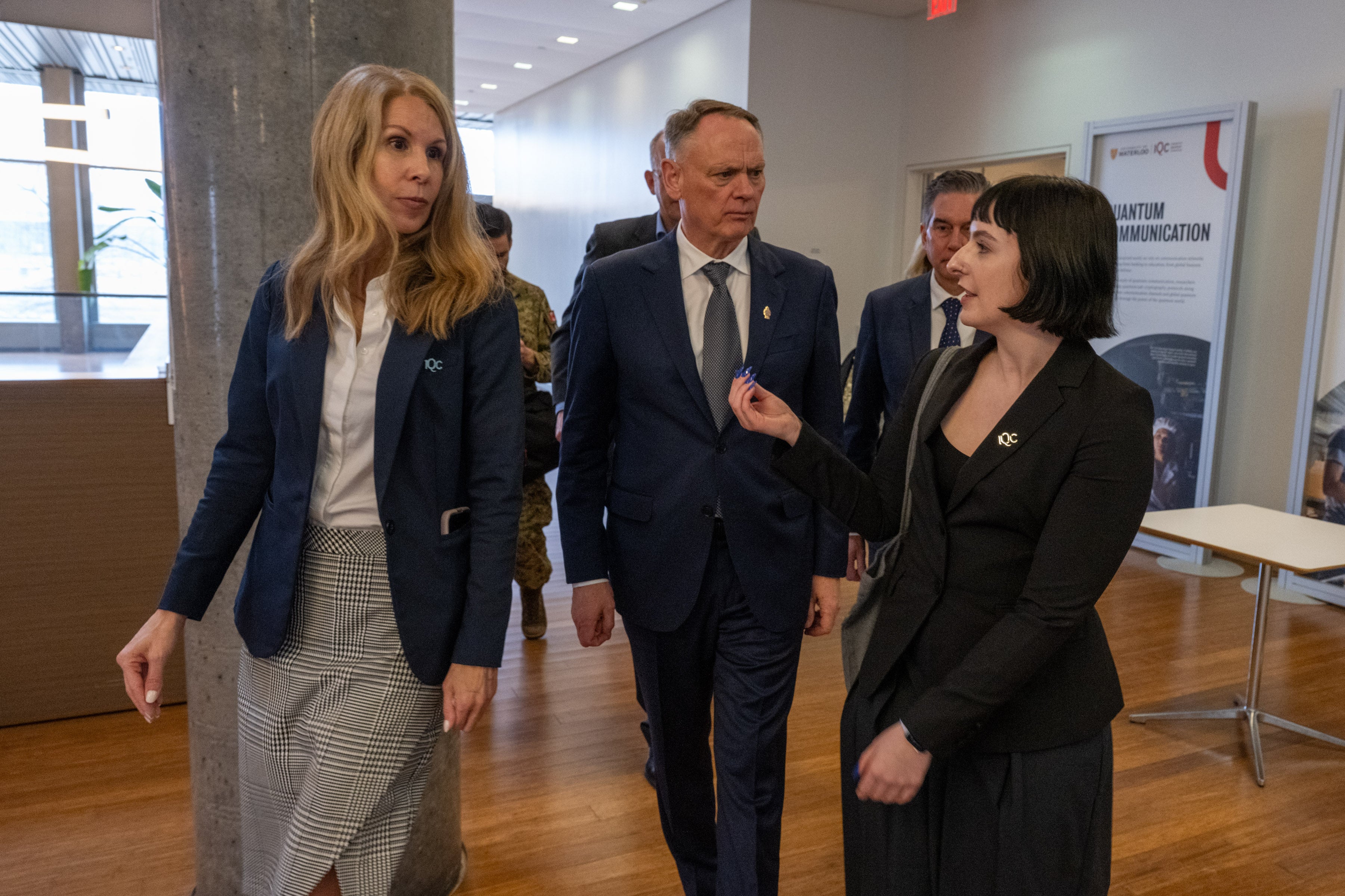 IQC's Siobhan Stables and Fiona Thompson walk with Defence Minister at IQC