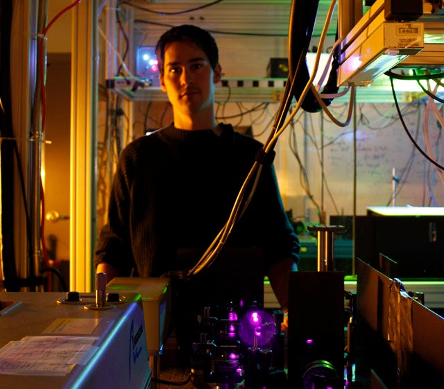 Jonathan Lavoie standing next to the experimental setup 