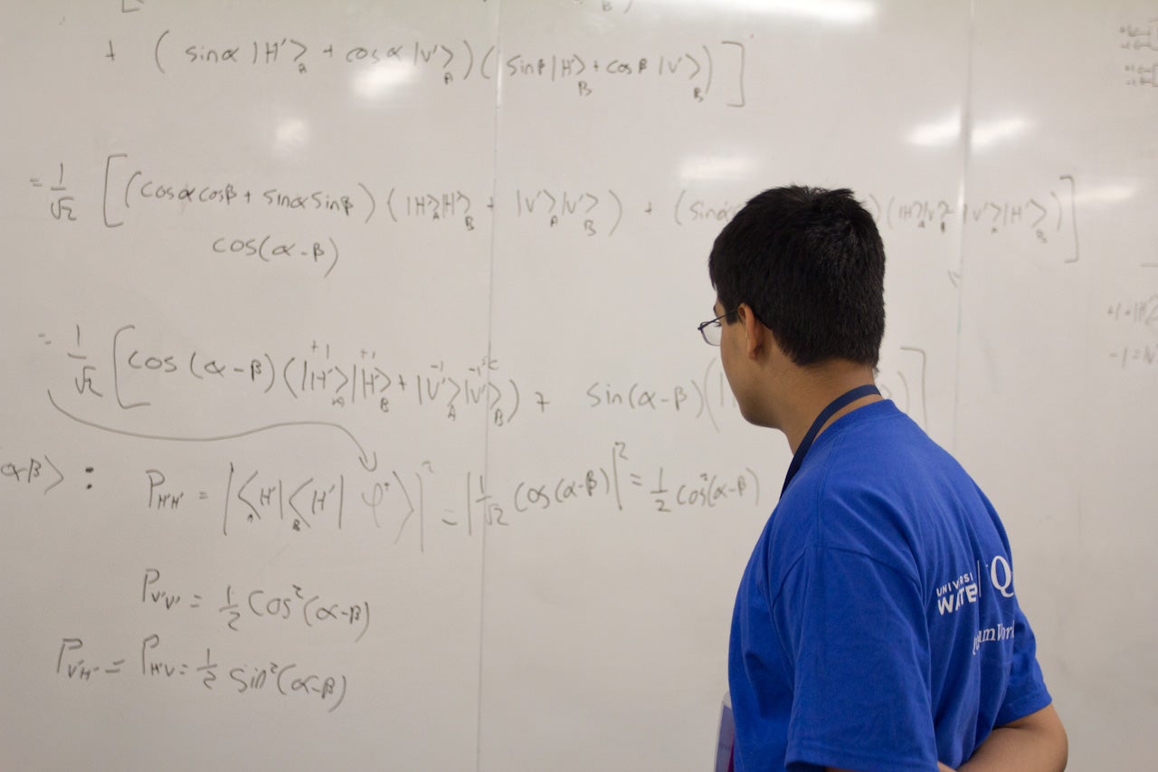 Student readin an equation on a white board
