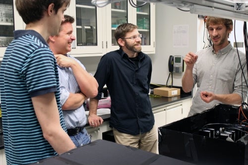 The researchers interact in a quantum optics lab