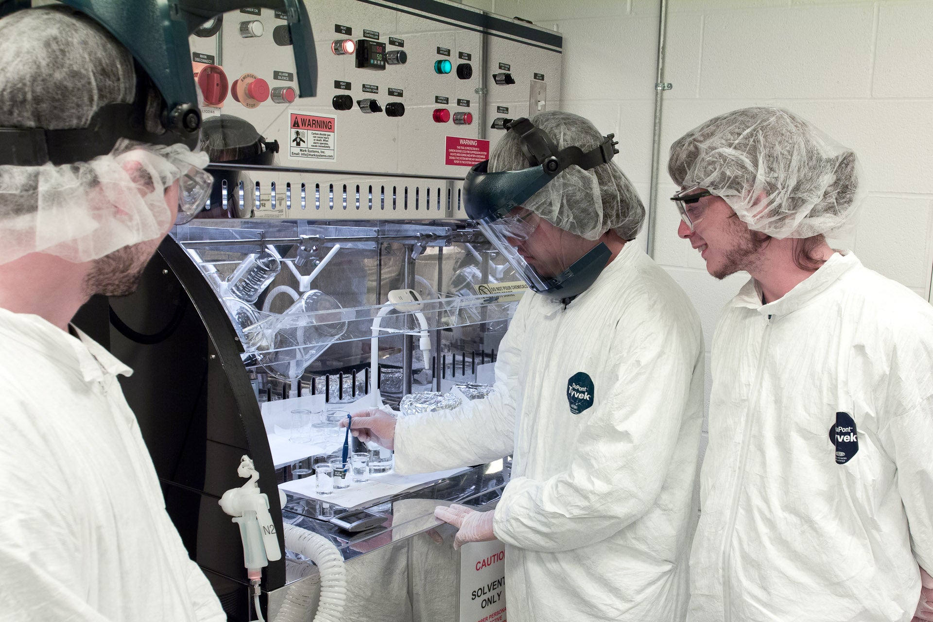 Student preforming experiment in cleanroom 