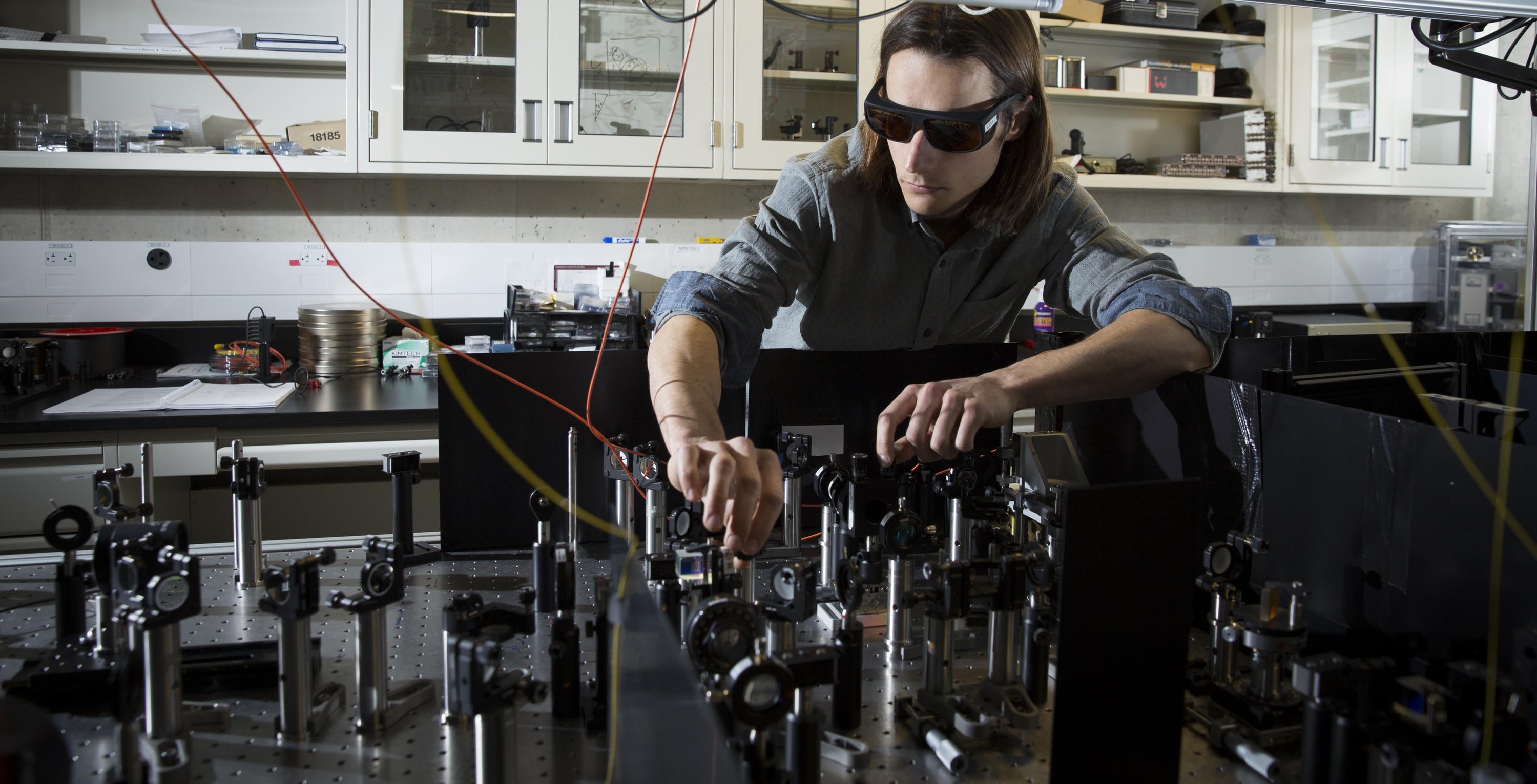 Jean-Philippe MacLean works on his optics experiment