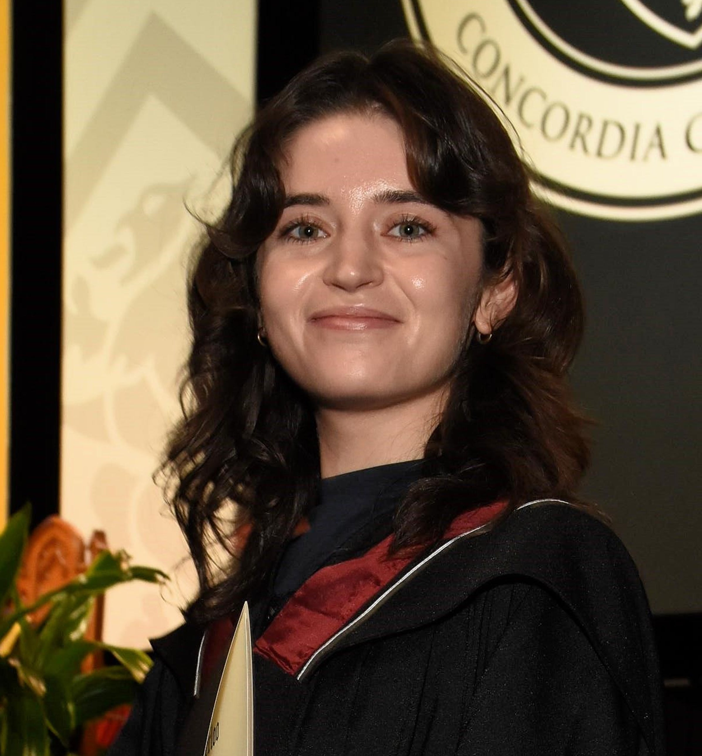 Katya Dricsoll holding a rose at a University of Waterloo graduation ceremony