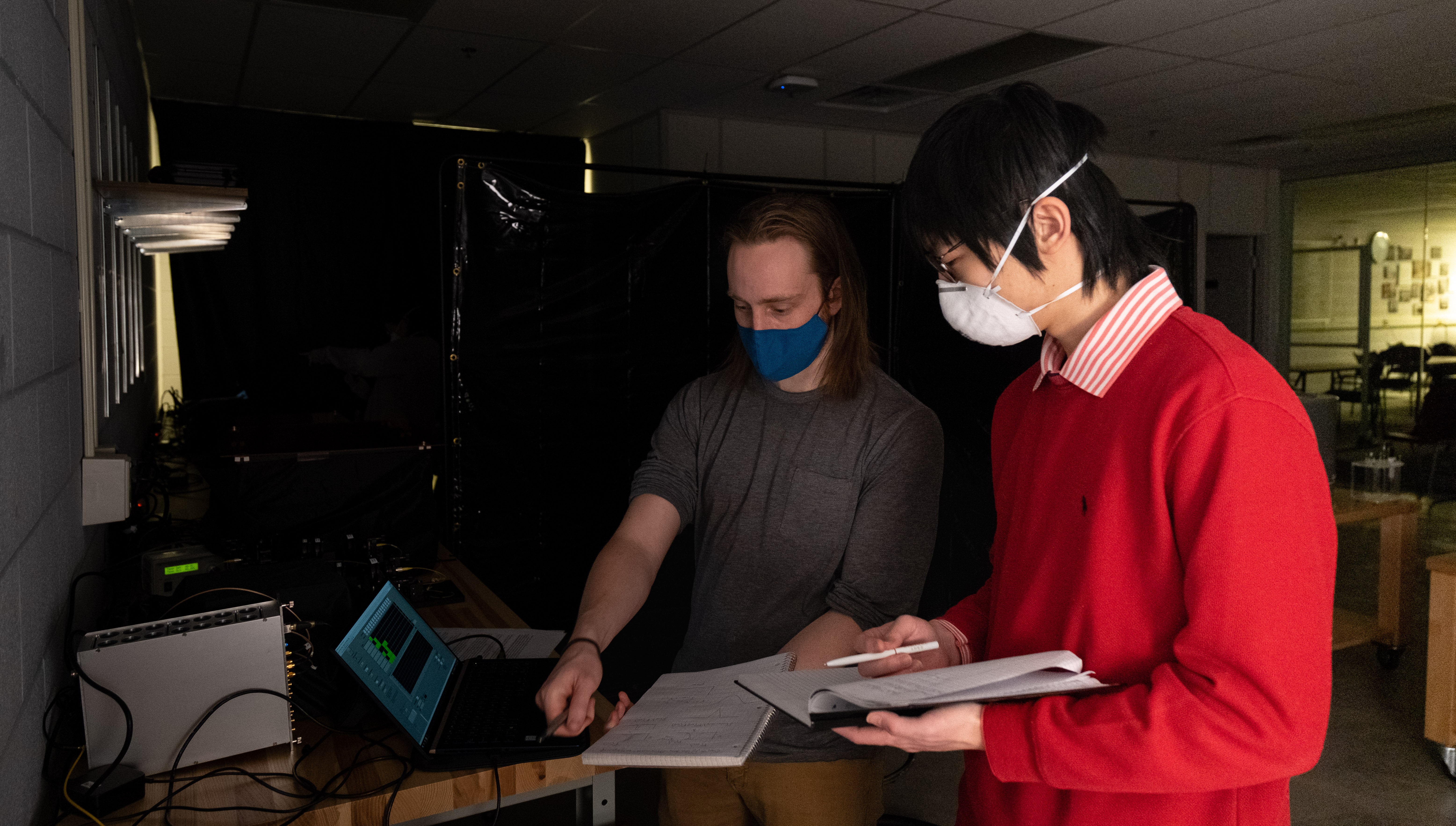 two students looking at a laptop