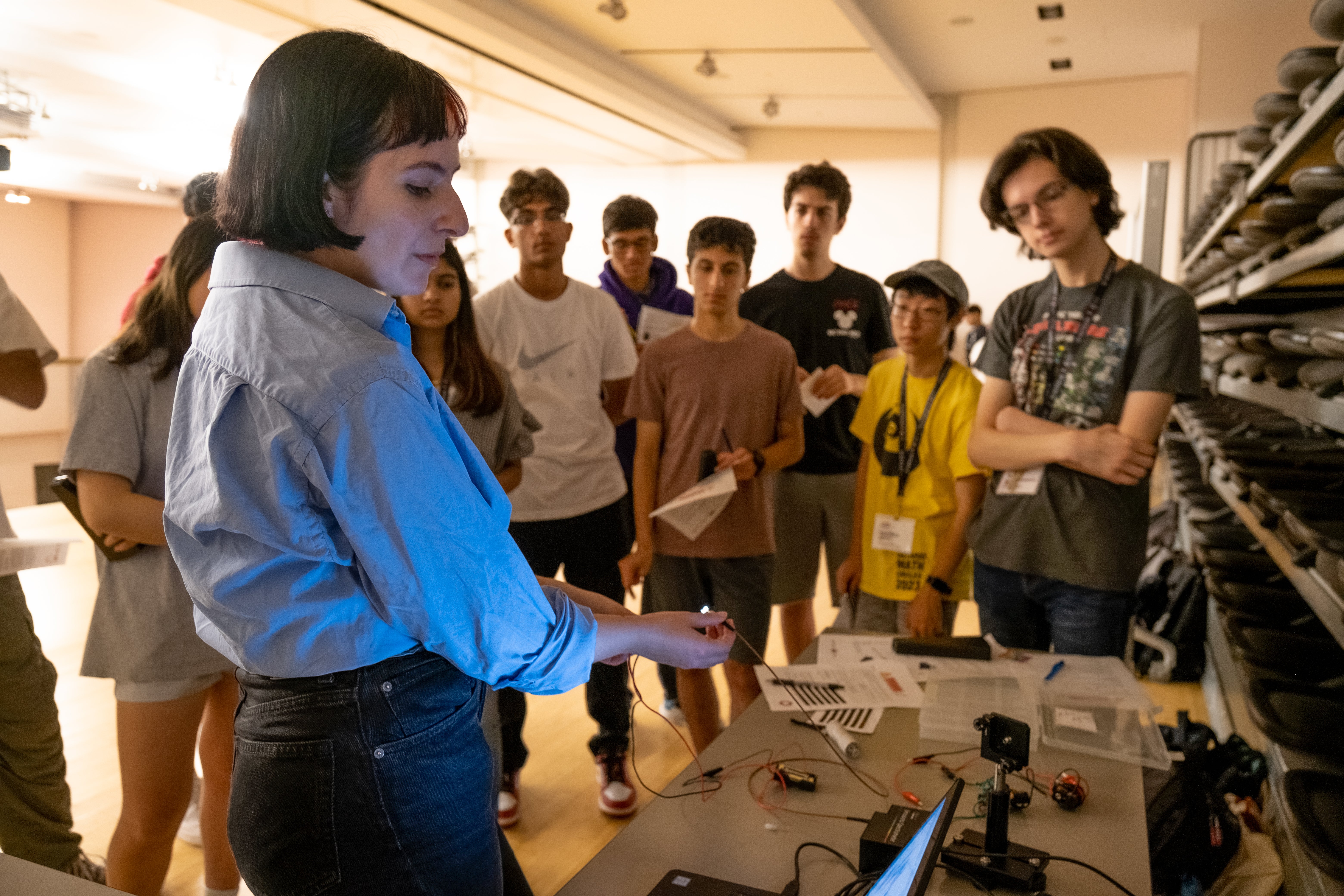 Fiona Thompson demonstrating an outreach lab activity to a group of high school students