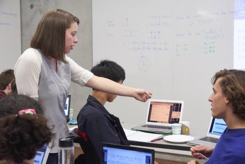 Sarah Sheldon, IBM research staff member, helps USEQIP students run their experiments on the IBM Quantum Experience platform