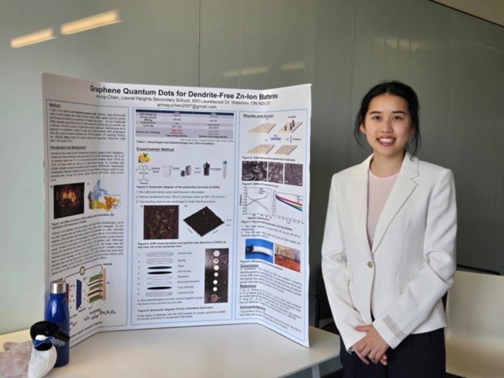 Anna Chen standing beside a trifold presentation board