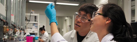 Banner students looking at an item in the lab