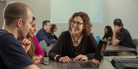 3 people sitting at a table talking