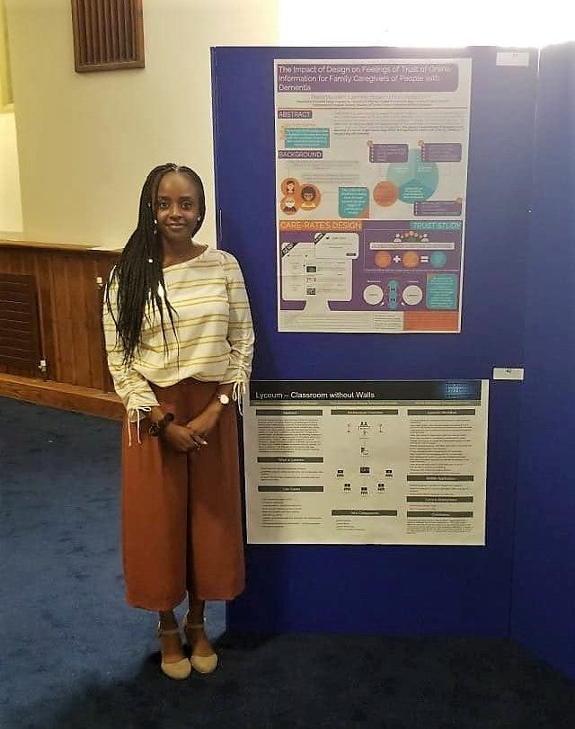 Thana standing by her poster at BHCI-2018
