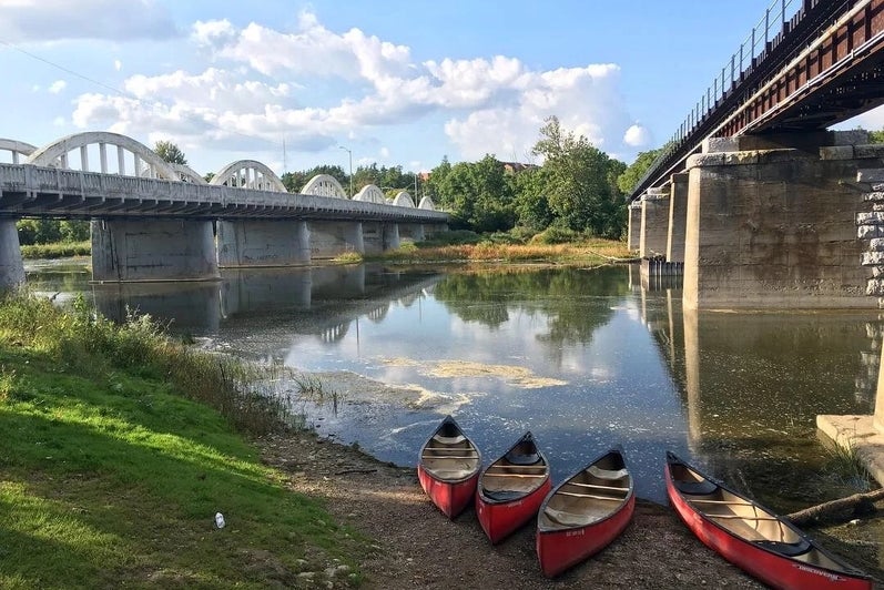 Canoes on a bank of the Grand River in Waterloo, Ontario.