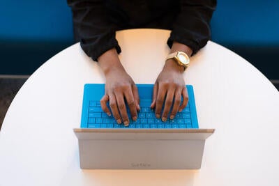 Person typing on computer.