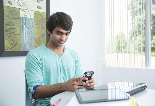 Male student using a smartphone