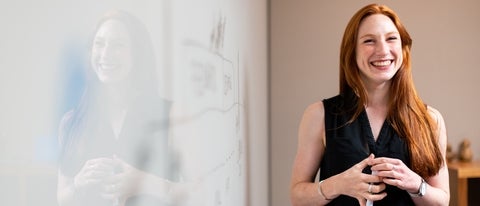 woman in front of white board