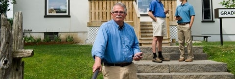 Eric Roy stands outside of the Grad House on campus.