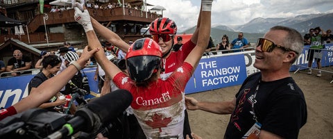 Rob Holgren with two teamates celebrating at finish line at the Andorra worlds.