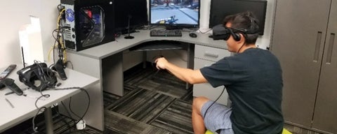 Male using VR equipment at a desk