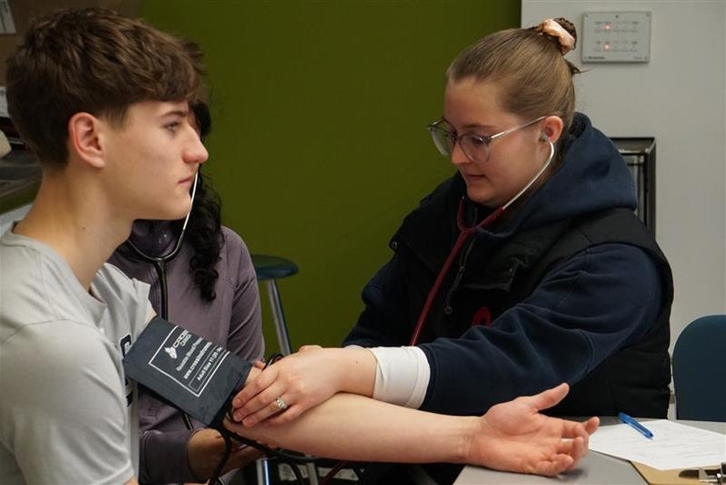 Student taking blood pressure